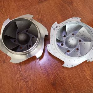 Customer's original impeller and the reverse engineered replacement side by side, both viewed into the suction eye