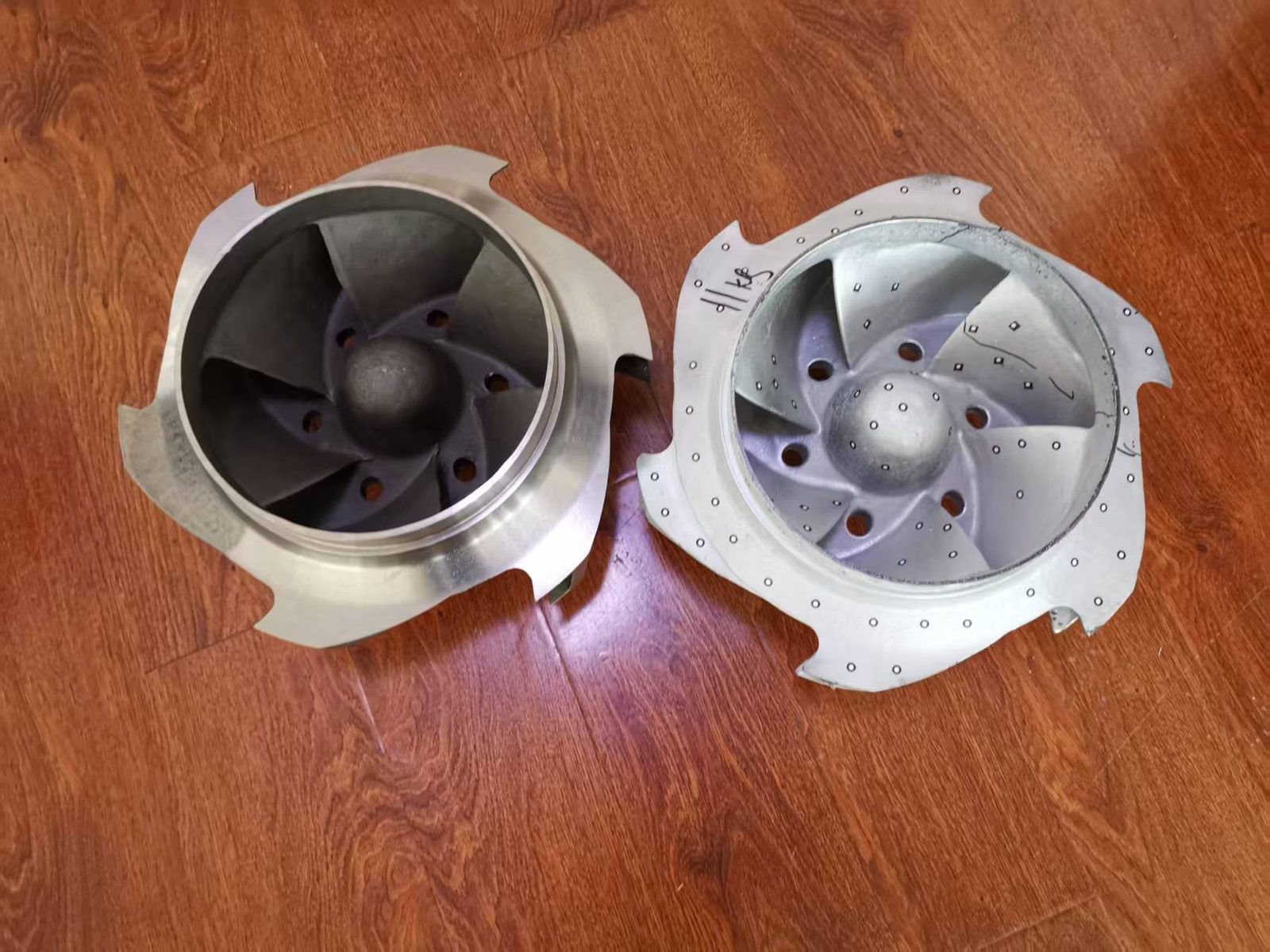 Customer’s original impeller and the reverse engineered replacement side by side, both viewed into the suction eye